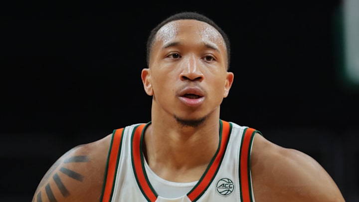 Dec 21, 2024; Coral Gables, Florida, USA; Miami Hurricanes guard Matthew Cleveland (0) high-fives with teammates after shooting a free-throw against the Mount St. Mary's Mountaineers during the second half at Watsco Center. Mandatory Credit: Sam Navarro-Imagn Images