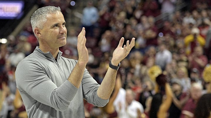 Mar 9, 2024; Tallahassee, Florida, USA; Florida State Seminoles head football coach Mike Norvell accepts the Bear Bryant coach of the Year award during a media timeout of a basketball game against the Miami Hurricanes at Donald L. Tucker Center. Mandatory Credit: Melina Myers-USA TODAY Sports