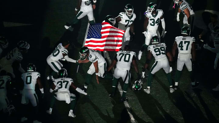 New York Jets quarterback Aaron Rodgers (8) runs onto the field to face the Buffalo Bills in the New York Jets quarterback Aaron Rodgers (8) runs onto the field to face the Buffalo Bills in the