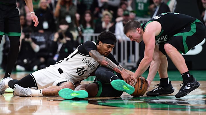 Mar 18, 2025; Boston, Massachusetts, USA; Brooklyn Nets guard Keon Johnson (45) Boston Celtics guard Jrue Holiday (4) and guard Payton Pritchard (11) all battle for the ball during the second half at TD Garden. Mandatory Credit: Bob DeChiara-Imagn Images