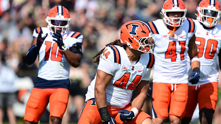 Illinois Fighting Illini defensive lineman Angelo McCullom (44) celebrates sacking Purdue Boilermakers quarterback Ryan Browne (15) during the second quarter at Ross-Ade Stadium. Illinois Fighting Illini defensive lineman Angelo McCullom (44) celebrates sacking Purdue Boilermakers quarterback Ryan Browne (15) during the second quarter at Ross-Ade Stadium.