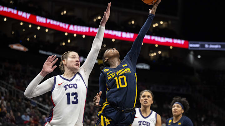 Mar 8, 2025; Kansas City, MO, USA; West Virginia Mountaineers guard Jordan Harrison (10) shoots the ball while defended by TCU Horned Frogs center Sedona Prince (13) during the second half at T-Mobile Center. Mandatory Credit: Amy Kontras-Imagn Images Mar 8, 2025; Kansas City, MO, USA; West Virginia Mountaineers guard Jordan Harrison (10) shoots the ball while defended by TCU Horned Frogs center Sedona Prince (13) during the second half at T-Mobile Center. Mandatory Credit: Amy Kontras-Imagn Images