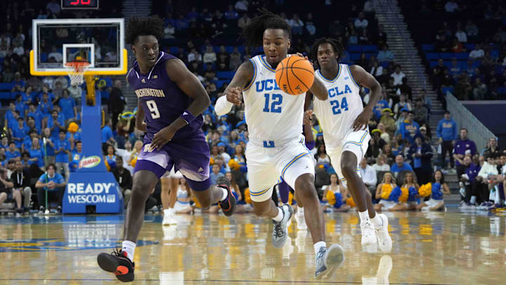 Dec 3, 2024; Los Angeles, California, USA; UCLA Bruins guard Sebastian Mack (12) dribbles the ball against Washington Huskies guard Zoom Diallo (9) in the second half at Pauley Pavilion presented by Wescom. Mandatory Credit: Kirby Lee-Imagn Images