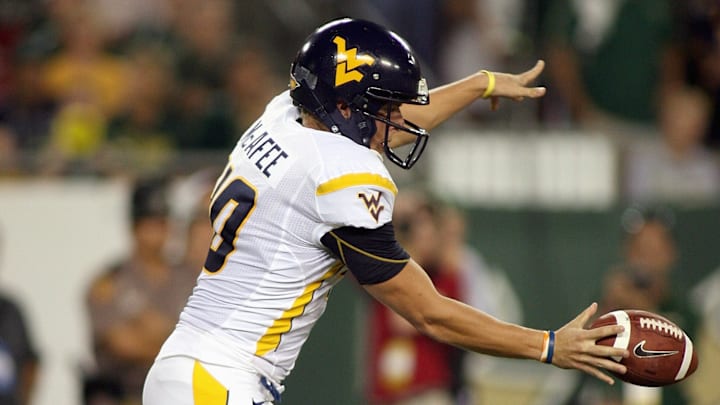 McAfee setting up a punt during his WVU career.