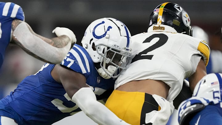Sep 29, 2024; Indianapolis, Indiana, USA;  Indianapolis Colts linebacker Jaylon Carlies (57) wraps up Pittsburgh Steelers quarterback Justin Fields (2) on Sunday, Sept. 29, 2024, during a game against the Pittsburgh Steelers at Lucas Oil Stadium. 