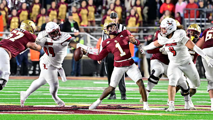 Oct 25, 2024; Chestnut Hill, Massachusetts, USA; Louisville Cardinals defensive lineman Dezmond Tell (99) blocks the arm of Boston College Eagles quarterback Thomas Castellanos (1) during the second half at Alumni Stadium. Mandatory Credit: Eric Canha-Imagn Images Oct 25, 2024; Chestnut Hill, Massachusetts, USA; Louisville Cardinals defensive lineman Dezmond Tell (99) blocks the arm of Boston College Eagles quarterback Thomas Castellanos (1) during the second half at Alumni Stadium. Mandatory Credit: Eric Canha-Imagn Images