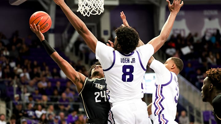 Mar 9, 2024; Fort Worth, Texas, USA; UCF Knights guard Jaylin Sellers (24) shoots past TCU Horned Frogs center Ernest Udeh Jr. (8) during the second half at Ed and Rae Schollmaier Arena. Mandatory Credit: Kevin Jairaj-Imagn Images