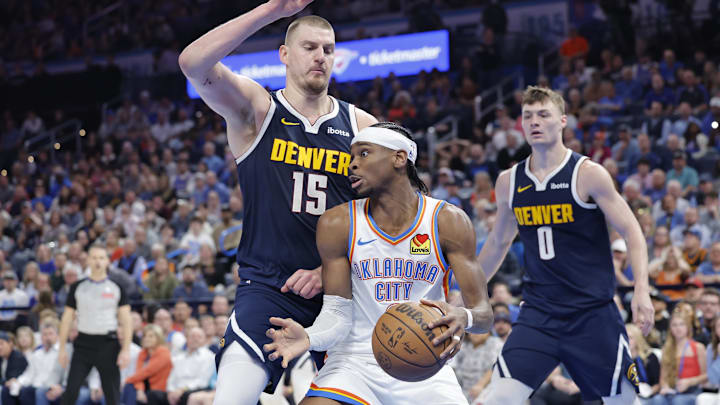 Mar 10, 2025; Oklahoma City, Oklahoma, USA; Denver Nuggets center Nikola Jokic (15) defends a drive by Oklahoma City Thunder guard Shai Gilgeous-Alexander (2) during the second half at Paycom Center. Mandatory Credit: Alonzo Adams-Imagn Images Mar 10, 2025; Oklahoma City, Oklahoma, USA; Denver Nuggets center Nikola Jokic (15) defends a drive by Oklahoma City Thunder guard Shai Gilgeous-Alexander (2) during the second half at Paycom Center. Mandatory Credit: Alonzo Adams-Imagn Images