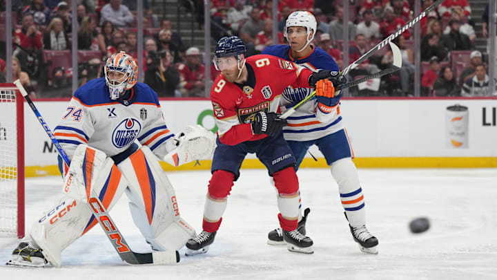Jun 9, 2025; Sunrise, Florida, USA; Edmonton Oilers goaltender Stuart Skinner (74) and defenseman Darnell Nurse (25) defend against Florida Panthers forward Sam Bennett (9) during the second period in game three of the 2025 Stanley Cup Final at Amerant Bank Arena. Mandatory Credit: Jim Rassol-Imagn Images