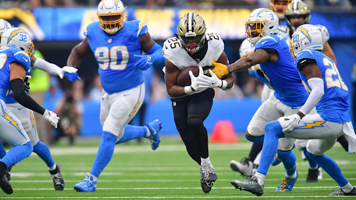 New Orleans Saints running back Kendre Miller (25) runs past Los Angeles Chargers safety Derwin James Jr. (3)