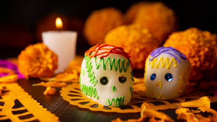 A traditional ofrenda decorated with sugar skulls, marigolds, and candles. A traditional ofrenda decorated with sugar skulls, marigolds, and candles.