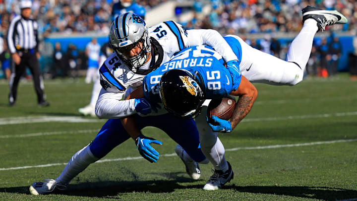 Carolina Panthers linebacker Kamu Grugier-Hill (54) tackles Jacksonville Jaguars tight end Brenton Strange (85) during the second quarter of a regular season NFL football matchup Sunday, Dec. 31, 2023 at EverBank Stadium in Jacksonville, Fla. The Jacksonville Jaguars blanked the Carolina Panthers 26-0. [Corey Perrine/Florida Times-Union]