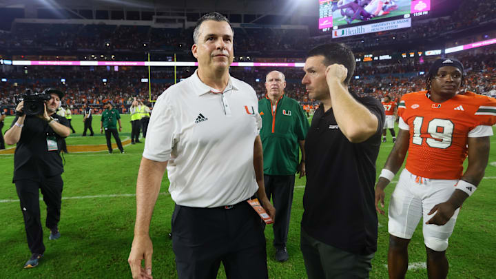 Sep 27, 2024; Miami Gardens, Florida, USA; Miami Hurricanes head coach Mario Cristobal walks on the field against the Virginia Tech Hokies as game officials review the last play of the game at Hard Rock Stadium. Mandatory Credit: Sam Navarro-Imagn Images Sep 27, 2024; Miami Gardens, Florida, USA; Miami Hurricanes head coach Mario Cristobal walks on the field against the Virginia Tech Hokies as game officials review the last play of the game at Hard Rock Stadium. Mandatory Credit: Sam Navarro-Imagn Images