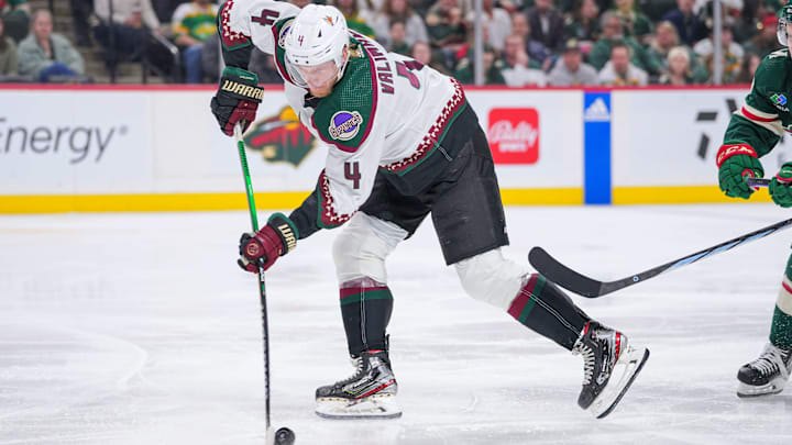 Mar 12, 2024; Saint Paul, Minnesota, USA; Arizona Coyotes defenseman Juuso Valimaki (4) carries the puck against the Minnesota Wild in the second period at Xcel Energy Center. Mandatory Credit: Brad Rempel-Imagn Images