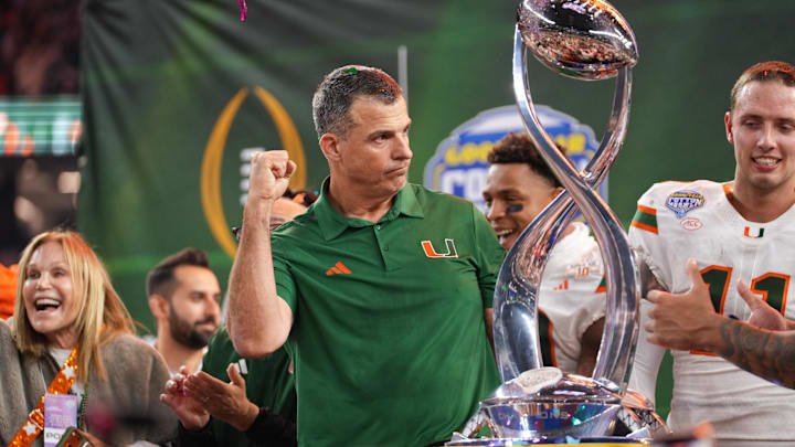 Dec 31, 2025; Arlington, TX, USA; Miami Hurricanes head coach Mario Cristobal lifts the Cotton Bowl trophy after the game against the Ohio State Buckeyes.
