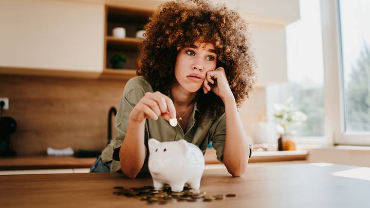 Woman saving money in piggy bank