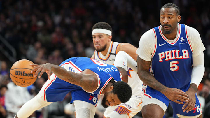 Nov 4, 2024; Phoenix, Arizona, USA; Philadelphia 76ers forward Paul George (8) is fouled by Phoenix Suns guard Devin Booker (1) during the second half at Footprint Center. Mandatory Credit: Joe Camporeale-Imagn Images