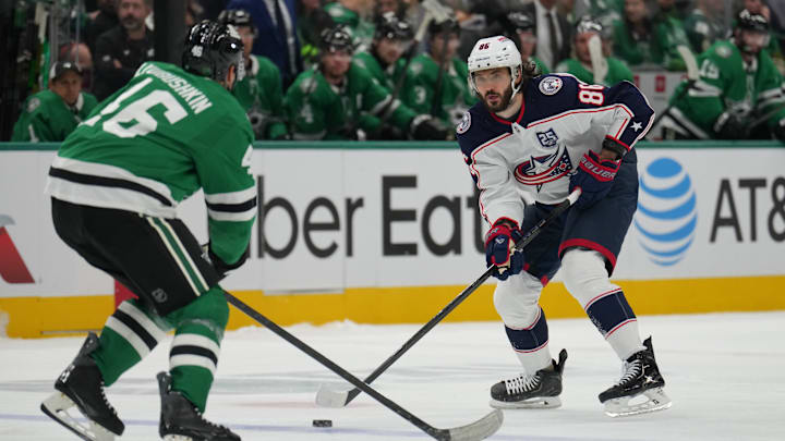 Blue Jackets forward Kirill Marchenko looks to make a play against Stars defenseman Ilya Lyubushkin. Blue Jackets forward Kirill Marchenko looks to make a play against Stars defenseman Ilya Lyubushkin.