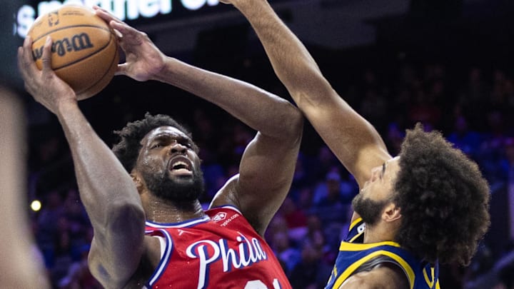 Dec 16, 2022; Philadelphia, Pennsylvania, USA; Philadelphia 76ers center Joel Embiid (21) drives for a score past Golden State Warriors forward Anthony Lamb (40) during the third quarter at Wells Fargo Center. Mandatory Credit: Bill Streicher-Imagn Images Dec 16, 2022; Philadelphia, Pennsylvania, USA; Philadelphia 76ers center Joel Embiid (21) drives for a score past Golden State Warriors forward Anthony Lamb (40) during the third quarter at Wells Fargo Center. Mandatory Credit: Bill Streicher-Imagn Images