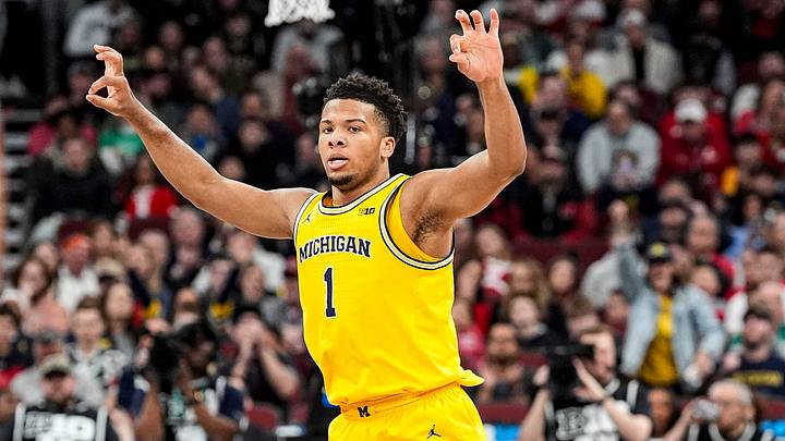 Michigan guard Trey McKenney (1) celebrates a 3-pointer against Wisconsin during the first half of Big Ten Tournament semifinal at United Center in Chicago on Saturday, March 14, 2026.