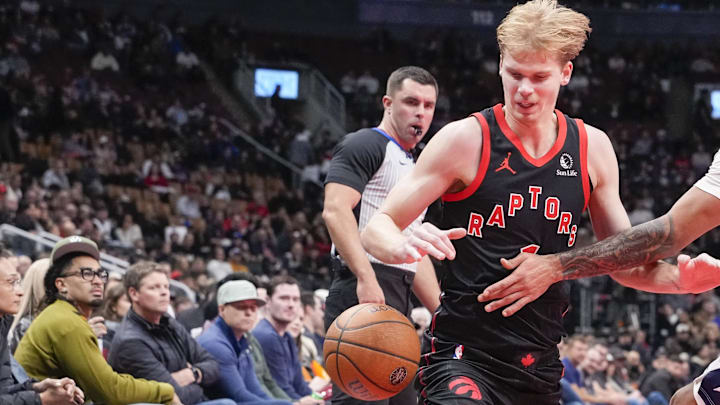 Nov 21, 2025; Toronto, Ontario, CAN; Gradey Dick (1) of the Toronto Raptors dribbles against Justin Champagnie (9) of the Washington Wizards during the second half at Scotiabank Arena. Mandatory Credit: Kevin Sousa-Imagn Images