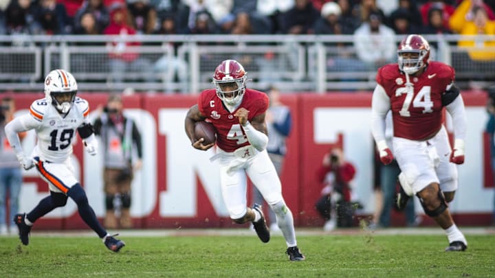 Nov 30, 2024; Tuscaloosa, Alabama, USA; Alabama Crimson Tide quarterback Jalen Milroe (4) runs the ball against the Auburn Tigers during the second quarter at Bryant-Denny Stadium. Mandatory Credit: Will McLelland-Imagn Images Nov 30, 2024; Tuscaloosa, Alabama, USA; Alabama Crimson Tide quarterback Jalen Milroe (4) runs the ball against the Auburn Tigers during the second quarter at Bryant-Denny Stadium. Mandatory Credit: Will McLelland-Imagn Images