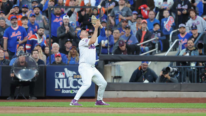 Oct 18, 2024; New York City, New York, USA; New York Mets first base Pete Alonso (20) makes a catch for against the New York Mets out in the second inning against the Los Angeles Dodgers during game five of the NLCS for the 2024 MLB playoffs at Citi Field. Mandatory Credit: Brad Penner-Imagn Images