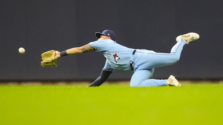 Apr 14, 2026; Milwaukee, Wisconsin, USA;  Toronto Blue Jays right fielder Nathan Lukes (38) dives for the ball hit by Milwaukee Brewers right fielder Sal Frelick (10) (not pictured) during the third inning at American Family Field. Mandatory Credit: Jeff Hanisch-Imagn Images