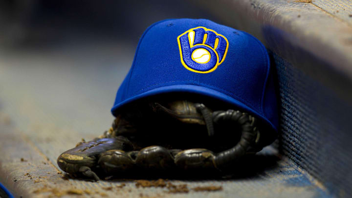 June 10, 2011; Milwaukee, WI, USA;   A Milwaukee Brewers hat and glove during the game against the St. Louis Cardinals at Miller Park.  The Brewers defeated the Cardinals 8-0. Mandatory Credit: Jeff Hanisch-Imagn Images