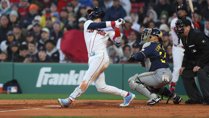 Apr 6, 2026; Boston, Massachusetts, USA; Boston Red Sox shortstop Trevor Story (10) hits an RBI single during the first inning against the Milwaukee Brewers at Fenway Park. Mandatory Credit: Paul Rutherford-Imagn Images