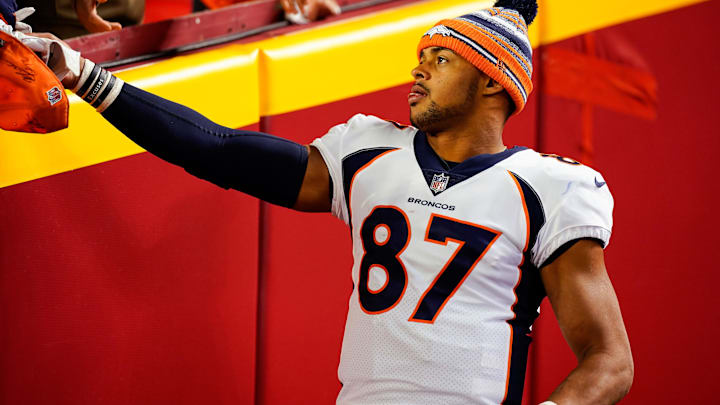 Dec 5, 2021; Kansas City, Missouri, USA; Denver Broncos tight end Noah Fant (87) gives a glove to a fan as he leaves the field after the game against the Kansas City Chiefs at GEHA Field at Arrowhead Stadium. Mandatory Credit: Jay Biggerstaff-Imagn Images