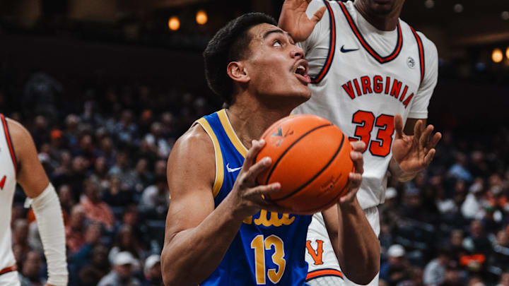 Feb 3, 2026; Charlottesville, Virginia, USA; Pittsburgh Panthers forward Roman Siulepa (13) prepares to shoot the ball while Virginia Cavaliers center Ugonna Onyenso (33) defends in the first half at John Paul Jones Arena. Mandatory Credit: Emily Faith Morgan-Imagn Images