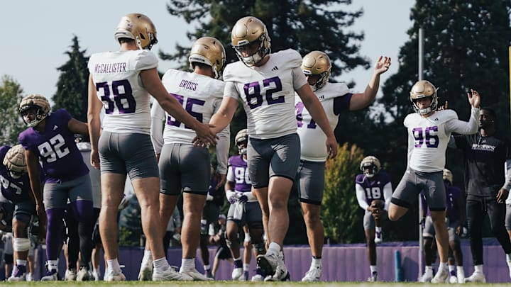Caleb Johnston (82), shaking hands with punter Jack McCallister, is in the mix to handle the UW long-snapping duties. Caleb Johnston (82), shaking hands with punter Jack McCallister, is in the mix to handle the UW long-snapping duties.