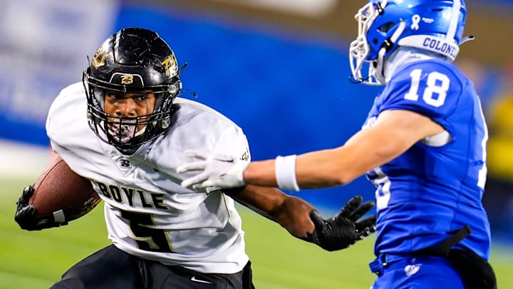 Boyle County wide receiver Montavin Quisenberry (5) stiff arms Covington Catholic Colonels defensive back Joseph Harney (18) during the KHSAA Class 4A 2023 UK HealthCare Sports Medicine state finals football game between Covington Catholic Colonels (14-0) and Boyle County Rebels (14-0) on Friday, Dec. 1, 2023, at Kroger Field in Lexington, Ky. Boyle County won 41-0.