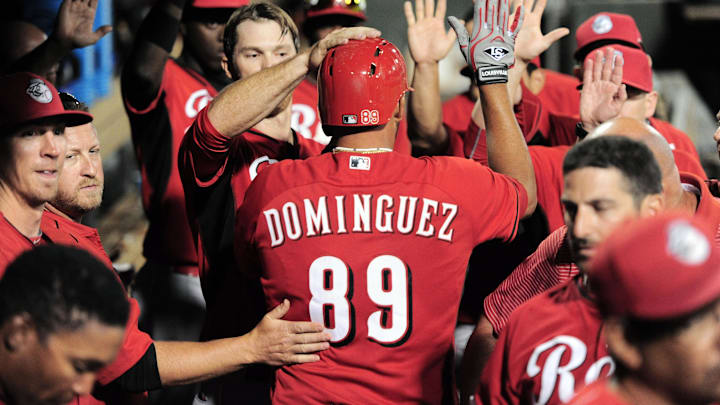 Mar 23, 2015; Surprise, AZ, USA; Cincinnati Reds third baseman Chris Dominguez (89) celebrates with teammates in the dugout after scoring a run against the Texas Rangers at Surprise Stadium. Mandatory Credit: Joe Camporeale-Imagn Images