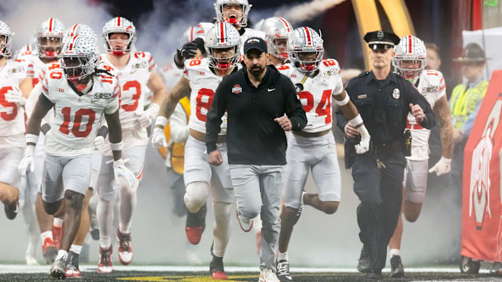 Jan 20, 2025; Atlanta, GA, USA; Ohio State Buckeyes head coach Ryan Day leads his team onto the field for the game against the Notre Dame Fighting Irish during the CFP National Championship college football game at Mercedes-Benz Stadium. Mandatory Credit: Mark J. Rebilas-Imagn Images Jan 20, 2025; Atlanta, GA, USA; Ohio State Buckeyes head coach Ryan Day leads his team onto the field for the game against the Notre Dame Fighting Irish during the CFP National Championship college football game at Mercedes-Benz Stadium. Mandatory Credit: Mark J. Rebilas-Imagn Images