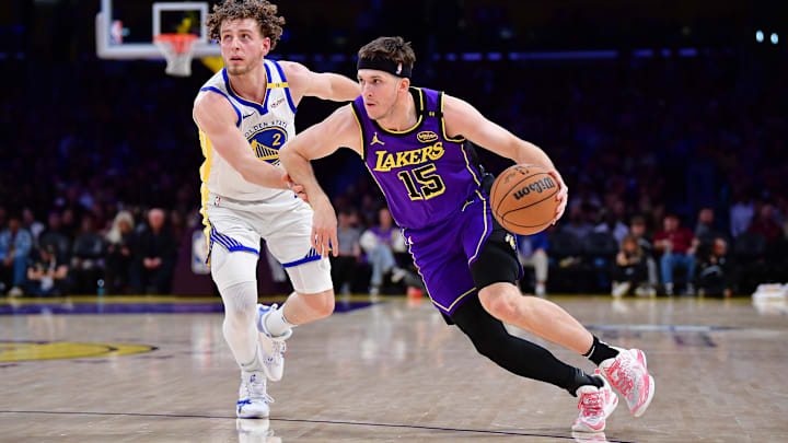 Feb 6, 2025; Los Angeles, California, USA; Los Angeles Lakers guard Austin Reaves (15) moves the ball against Golden State Warriors guard Brandin Podziemski (2) during the first half at Crypto.com Arena. Mandatory Credit: Gary A. Vasquez-Imagn Images