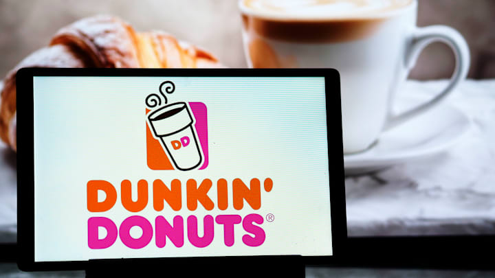 In this photo illustration, a Dunkin Donuts (Dunkin Brands...