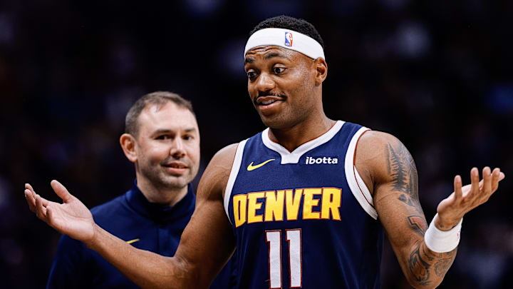 Oct 29, 2025; Denver, Colorado, USA; Denver Nuggets guard Bruce Brown (11) reacts as head coach David Adelman looks on in the fourth quarter against the New Orleans Pelicans at Ball Arena. Mandatory Credit: Isaiah J. Downing-Imagn Images