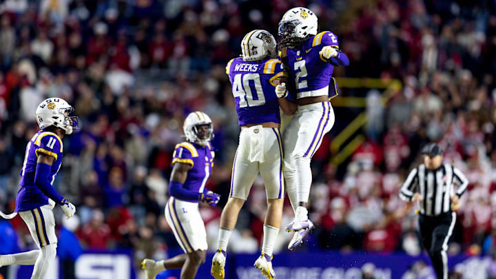 Nov 30, 2024; Baton Rouge, Louisiana, USA; LSU Tigers linebacker Whit Weeks (40) and LSU Tigers safety Jardin Gilbert (2) react to making a tackle against Oklahoma Sooners quarterback Jackson Arnold (11) during the fourth quarter at Tiger Stadium. Mandatory Credit: Stephen Lew-Imagn Images Nov 30, 2024; Baton Rouge, Louisiana, USA; LSU Tigers linebacker Whit Weeks (40) and LSU Tigers safety Jardin Gilbert (2) react to making a tackle against Oklahoma Sooners quarterback Jackson Arnold (11) during the fourth quarter at Tiger Stadium. Mandatory Credit: Stephen Lew-Imagn Images
