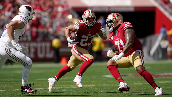 Oct 1, 2023; Santa Clara, California, USA; San Francisco 49ers running back Christian McCaffrey (23) runs the ball behind offensive tackle Trent Williams (71) against the Arizona Cardinals in the first quarter at Levi's Stadium. Mandatory Credit: Cary Edmondson-Imagn Images Oct 1, 2023; Santa Clara, California, USA; San Francisco 49ers running back Christian McCaffrey (23) runs the ball behind offensive tackle Trent Williams (71) against the Arizona Cardinals in the first quarter at Levi's Stadium. Mandatory Credit: Cary Edmondson-Imagn Images