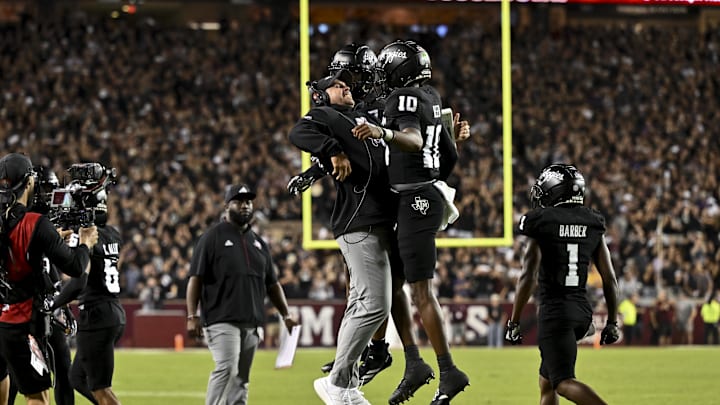 Oct 26, 2024; College Station, Texas, USA; Texas A&M Aggies quarterback Marcel Reed (10) celebrates after scoring a touchdown with Offensive Coordinator/Quarterbacks coach Collin Klein in the third quarter against the LSU Tigers at Kyle Field. Mandatory Credit: Maria Lysaker-Imagn Images. Oct 26, 2024; College Station, Texas, USA; Texas A&M Aggies quarterback Marcel Reed (10) celebrates after scoring a touchdown with Offensive Coordinator/Quarterbacks coach Collin Klein in the third quarter against the LSU Tigers at Kyle Field. Mandatory Credit: Maria Lysaker-Imagn Images.