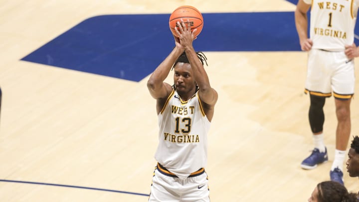 Feb 28, 2026; Morgantown, West Virginia, USA; West Virginia Mountaineers guard Chance Moore (13) shoots a free throw during the second half against the BYU Cougars at Hope Coliseum. Mandatory Credit: Ben Queen-Imagn Images