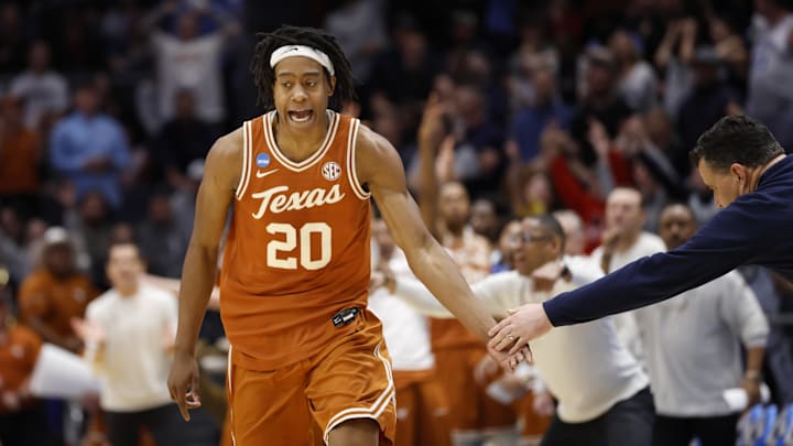Mar 19, 2025; Dayton, OH, USA; Texas Longhorns guard Tre Johnson (20) high fives Xavier Musketeers head coach Sean Miller after making a three point basket in the second half at UD Arena. Mandatory Credit: Rick Osentoski-Imagn Images