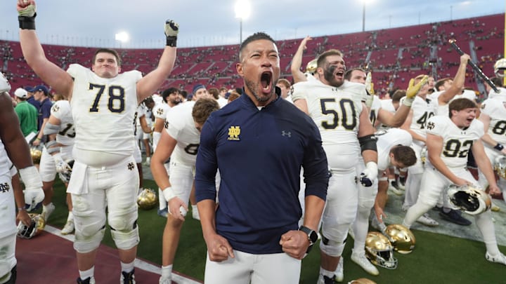 Nov 30, 2024; Los Angeles, California, USA; Notre Dame Fighting Irish head coach Marcus Freeman celebrates with players at the end of the game against the Southern California Trojans at United Airlines Field at Los Angeles Memorial Coliseum. Mandatory Credit: Kirby Lee-Imagn Images