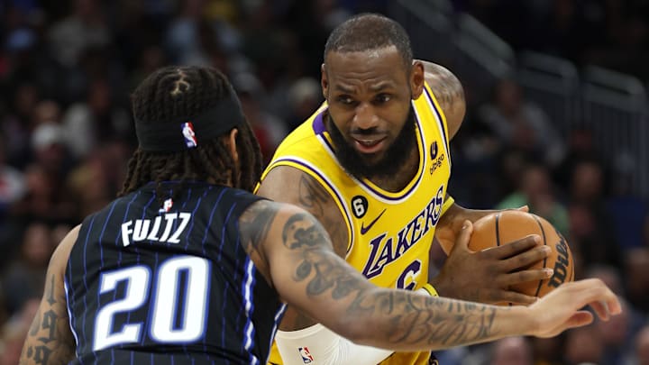 Dec 27, 2022; Orlando, Florida, USA; Los Angeles Lakers forward LeBron James (6) drives to the basket as Orlando Magic guard Markelle Fultz (20) defends during the second half at Amway Center. Mandatory Credit: Kim Klement-Imagn Images