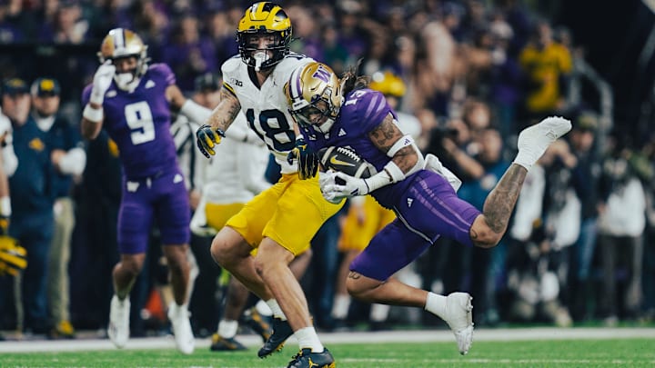 Kam Fabiculanan makes a fourth-quarter interception against Michigan. 