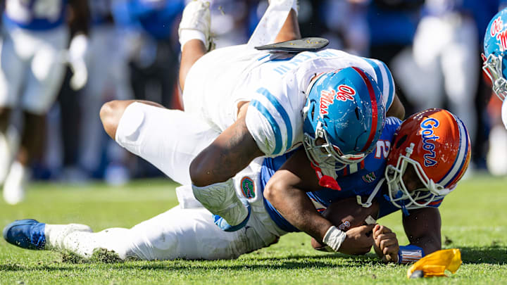 Nov 23, 2024; Gainesville, Florida, USA; Mississippi Rebels defensive tackle Walter Nolen (2) sacks Florida Gators quarterback DJ Lagway (2) during the first half at Ben Hill Griffin Stadium.