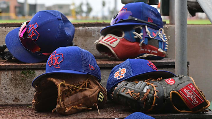A detail view of Texas Rangers hats and gloves during a Spring Training game against the San Francisco Giants at Scottsdale Stadium. 
