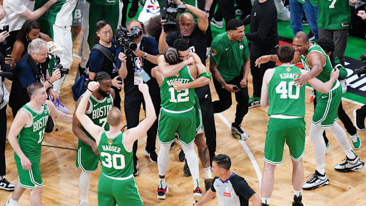 Jun 17, 2024; Boston, Massachusetts, USA; Boston Celtics forward Jayson Tatum (0) celebrates with forward Oshae Brissett (12) after defeating the Dallas Mavericks in game five to win the 2024 NBA Finals at TD Garden. Mandatory Credit: David Butler II-Imagn Images